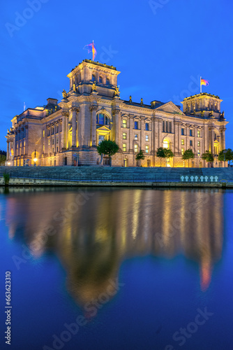 The imposing Reichstag, the german parliament building, at the river Spree at twilight