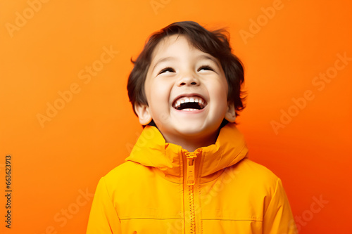 Happy children laughing/smiling, orange background, warm color background