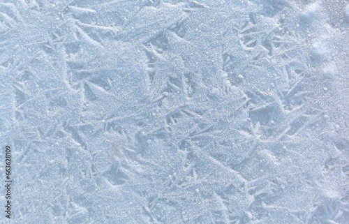 White abstract cold natural texture of icy sea shore on cold day. Winter background of small ice crystals on frozen water surface. Empty space for text. Top view, flat lay, copy space, mockup, blank