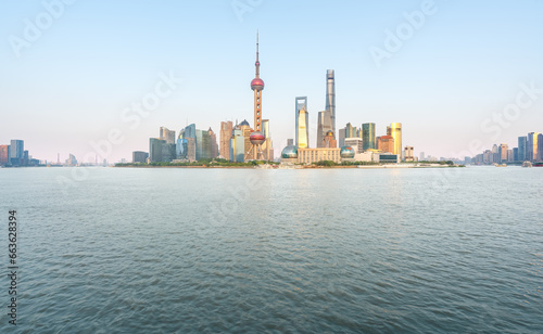 financial district buildings of shanghai and the yacht docked at the dock in morning
