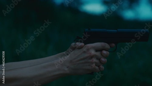 close-up of female hands with a gun, slider shot