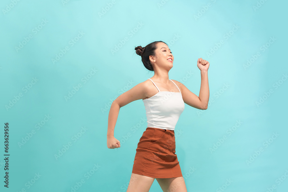 Happy attractive woman dancing and having fun, raising hands up carefree Happy attractive woman dancing and having fun, raising hands up carefree