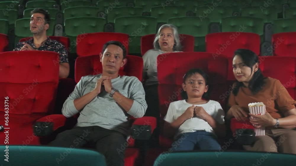 Various people in theater. Asian family and multiracial audiences are scared of watching thriller and horror cinema, frightened together on movie stage, and entertainment lifestyle with film art show. Various people in theater. Asian family and multiracial audiences are scared of watching thriller and horror cinema, frightened together on movie stage, and entertainment lifestyle with film art show.