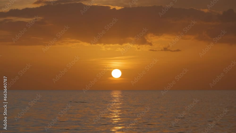 Ocean sunset. Big white sun on dramatic bright sky background, soft evening horizon over sea dark water Ocean sunset. Big white sun on dramatic bright sky background, soft evening horizon over sea dark water