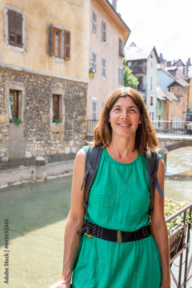 Beautiful woman middle aged tourist in city street happy laughing in annecy town