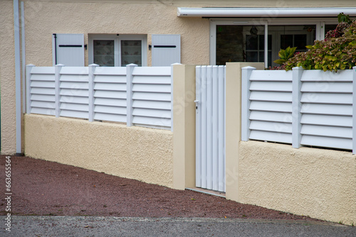 Fototapeta Naklejka Na Ścianę i Meble -  small door white aluminum house facade access home garden