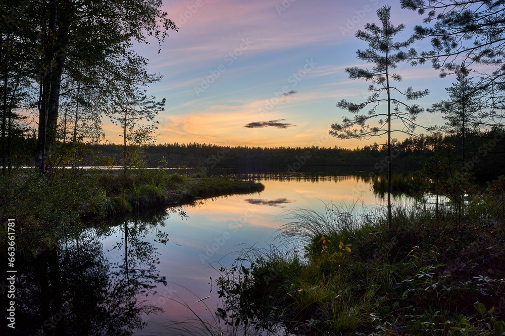 Scenic view of a tranquil lake at sunset