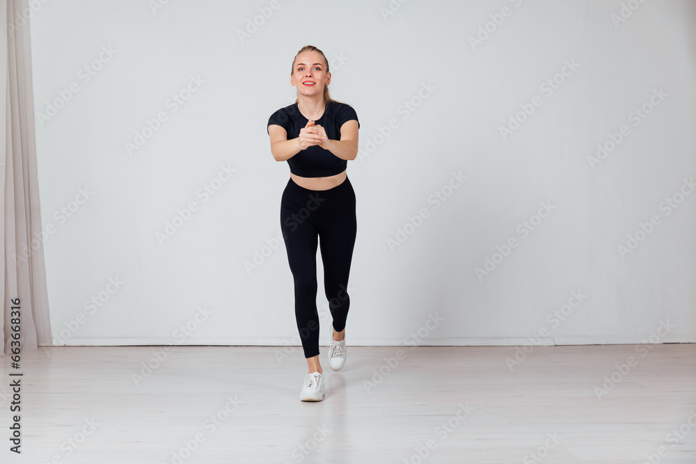 a woman doing exercises in a bright room exercises warm-up