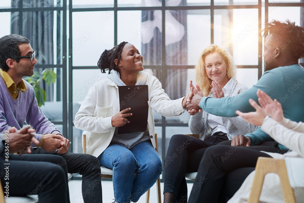 conducts business training with a group of young people. conducts business training with a group of young people.