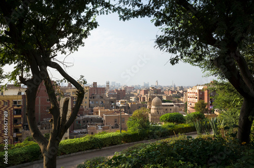 Cairo old town cityscape view from Al Azhar Park framed with trees, Egypt, Middle east urban panorama photo