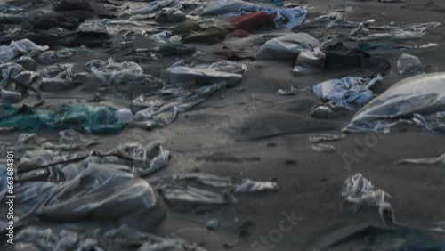 Drone shot revealing plastic waste on the beach shore, Water pollution, Fashion Waste, Ocean garbage with the view of the beach under foggy sky photo