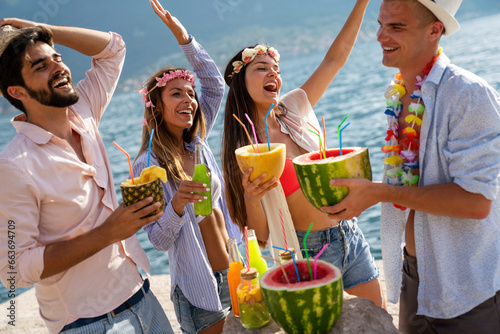 Multiracial group of friends enjoying summer vacation with cocktails. People, travel concept