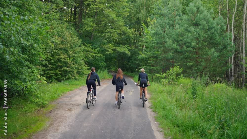 Enjoy Summer Weekend, Three Women Riding Bikes In Nature, Riding In Sunny Day In Forest Enjoy Summer Weekend, Three Women Riding Bikes In Nature, Riding In Sunny Day In Forest