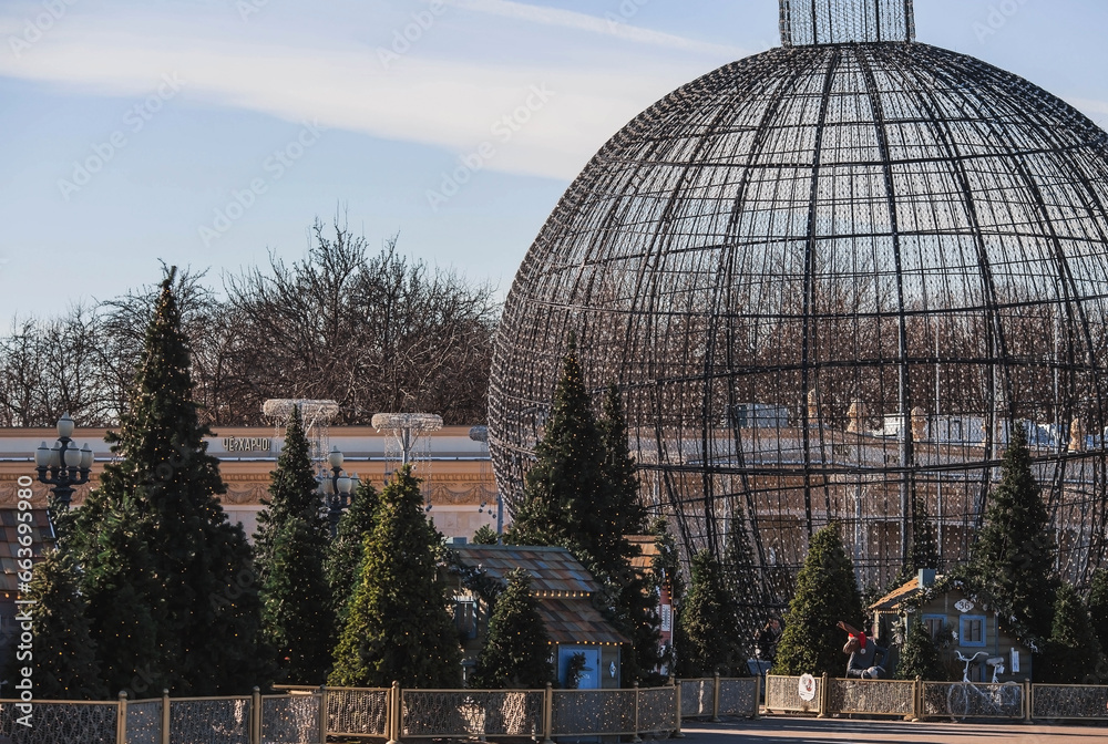 Obraz premium New Year. Christmas decorations on the streets of Moscow 2024. Small houses, Christmas trees and a big ball. Christmas market in Gorky Park.