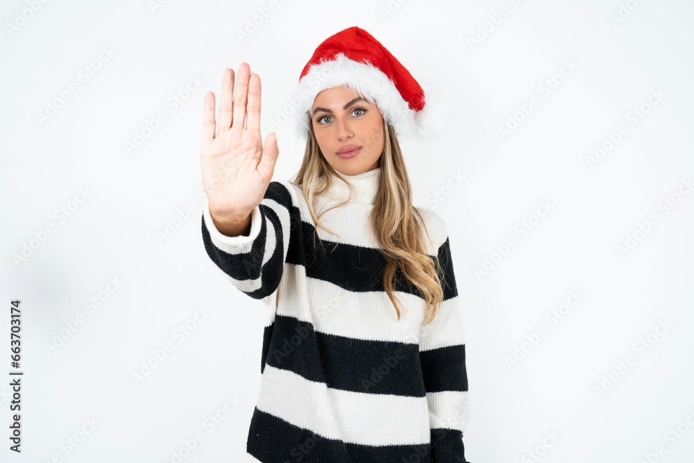 Young beautiful woman doing stop sing with palm of the hand. Warning expression with negative and serious gesture on the face.