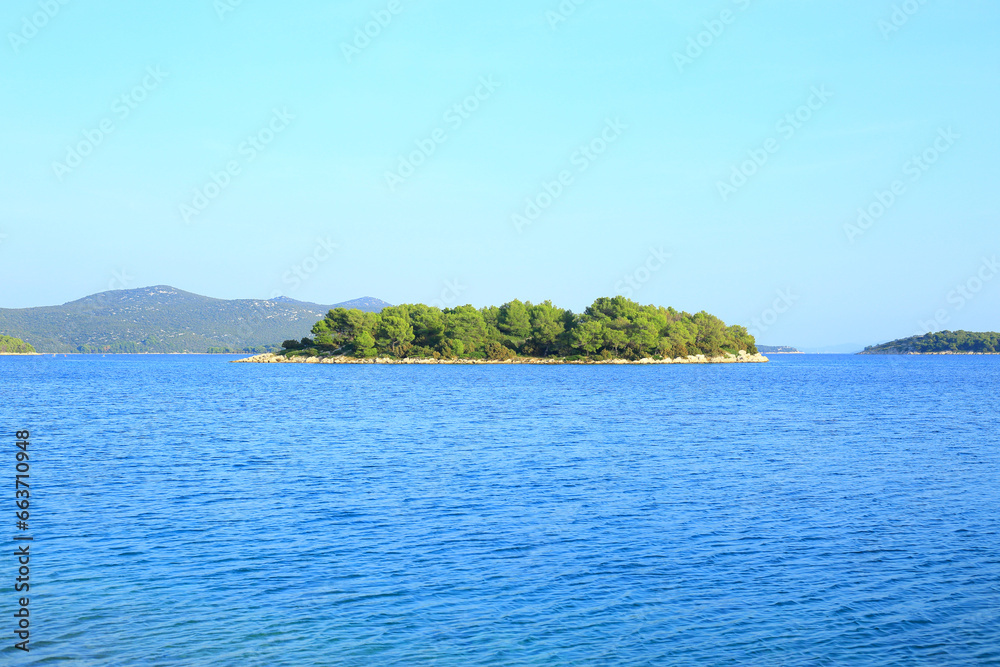 Island Murter in Croatia. View to the small islet overgrowth wit vegetation.