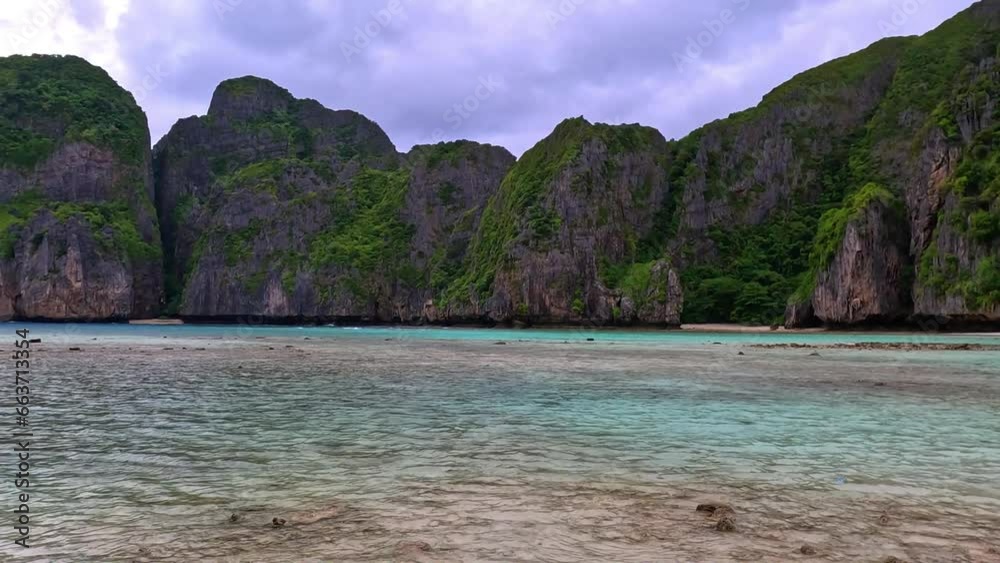 Phi Phi island off the coast of phuket thailand. Phi phi island is famous for turquoise clear blue waters teaming with Corel reef fish white soft sand and lush green trees. Phi Phi island off the coast of phuket thailand. Phi phi island is famous for turquoise clear blue waters teaming with Corel reef fish white soft sand and lush green trees.