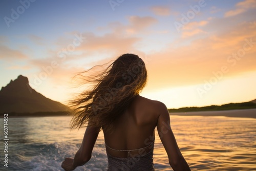 Rear view of a beautiful young woman with long hair flying in the air and enjoying the sunset on the beach, Female surfer rear view in sea at sunset, Oahu, Hawaii, United States, AI Generated © Iftikhar alam