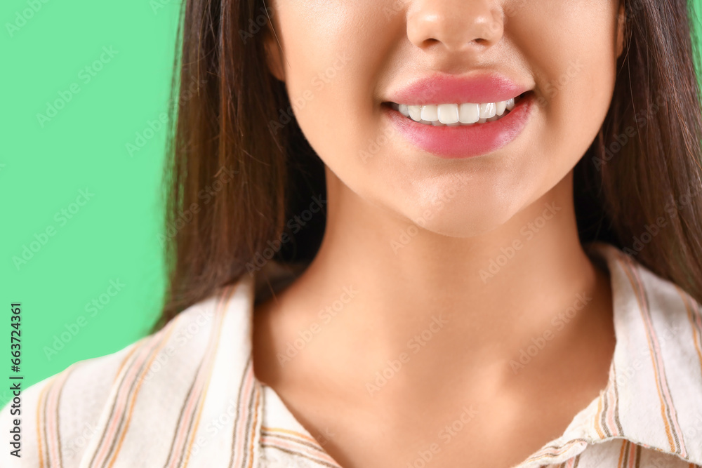 Smiling young woman with healthy teeth on green background, closeup Smiling young woman with healthy teeth on green background, closeup