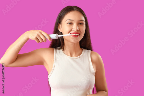 Smiling young asian woman b...