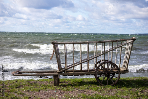  a wooden cart placed by the sea © Jorens