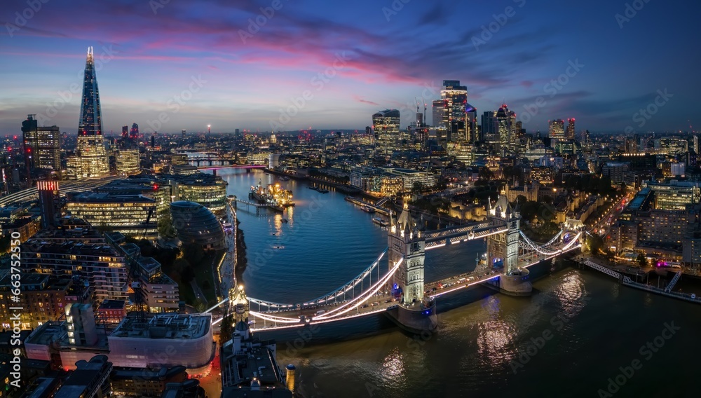 Panoramic view of the illuminated London skyline with Tower Bridge and river Thames until the City during night time