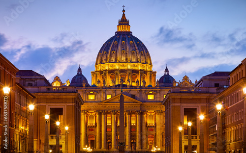 Vatican City (Holy See. Rome, Italy. Dome of St. Peters Basil cathedral at Saint Peter's Square. Evening sunset, golden hour with evening sky and street lamps.