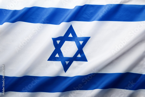 Israel flag. Independence Day of Israel. Israel flag beautifully waving wave with star of David over white wooden background. National pride of Israel. Patriotism and commonwealth. Top view. Mock up.