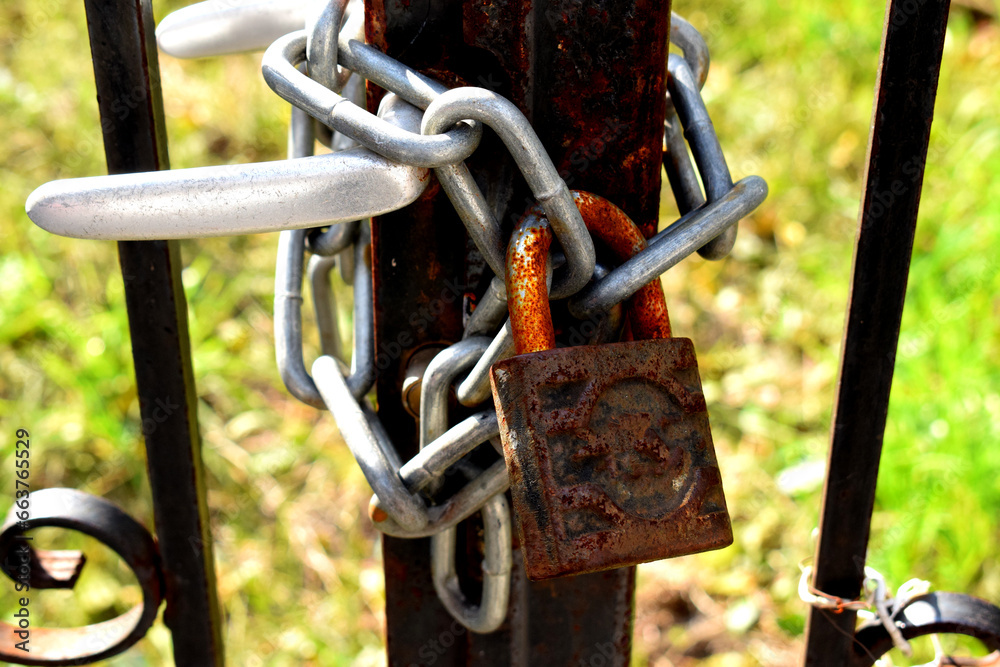 old rusty lock on closed gate entrance.padlock and chain old rusty lock on closed gate entrance.padlock and chain