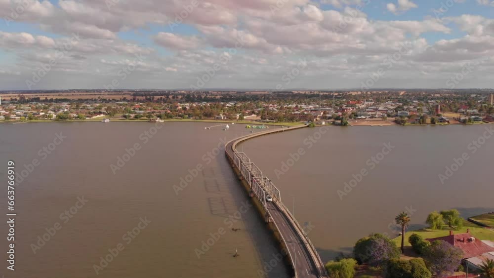 Descending aerial view showing cars exiting the Yarrawonga bridge from the NSW side Descending aerial view showing cars exiting the Yarrawonga bridge from the NSW side
