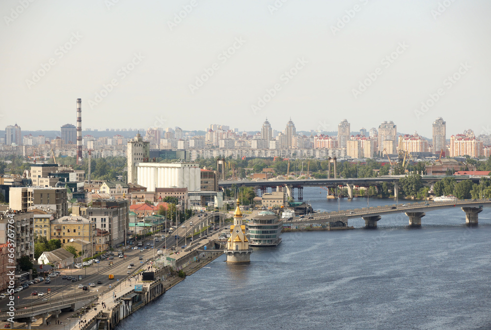 Panorama of the city of Kyiv from a bird's eye view. View of Podol from the south of the city of Kyiv in Ukraine. Industrial and historical center on the banks of the Dnieper River