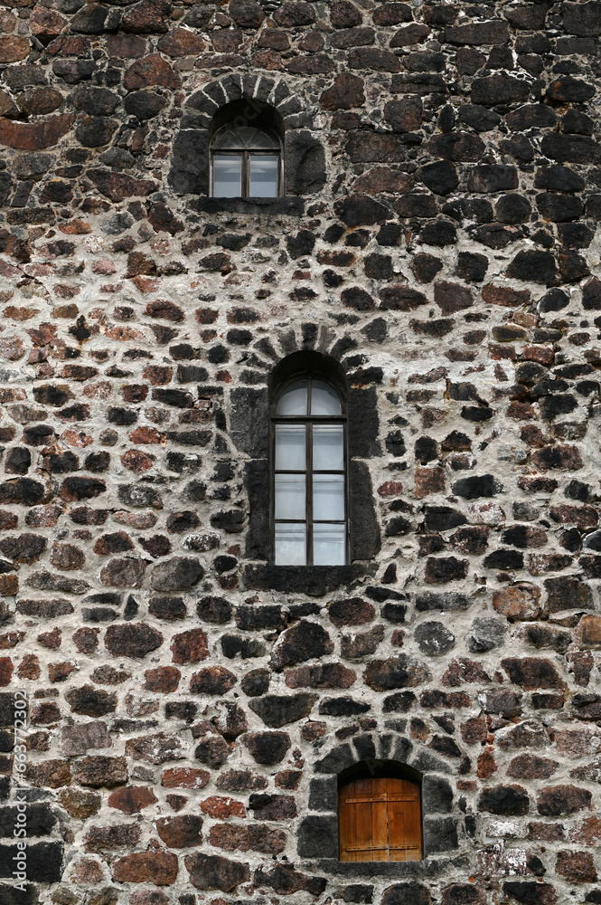 Windows in the stone wall of the castle, vertical picture