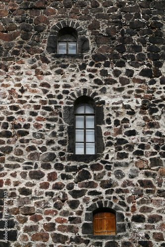 Windows in the stone wall of the castle, vertical picture