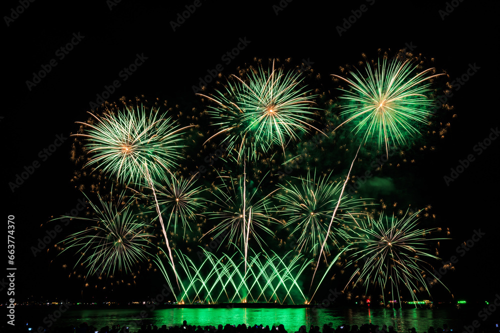Fototapeta premium Real Fireworks at Pattaya bay, Pattaya national Fireworks Festival contest, November of every Year, Beautiful of bright light fireworks Show in middle sea, for postcard wallpaper background,