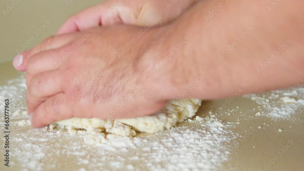 Hands kneading biscuits dough