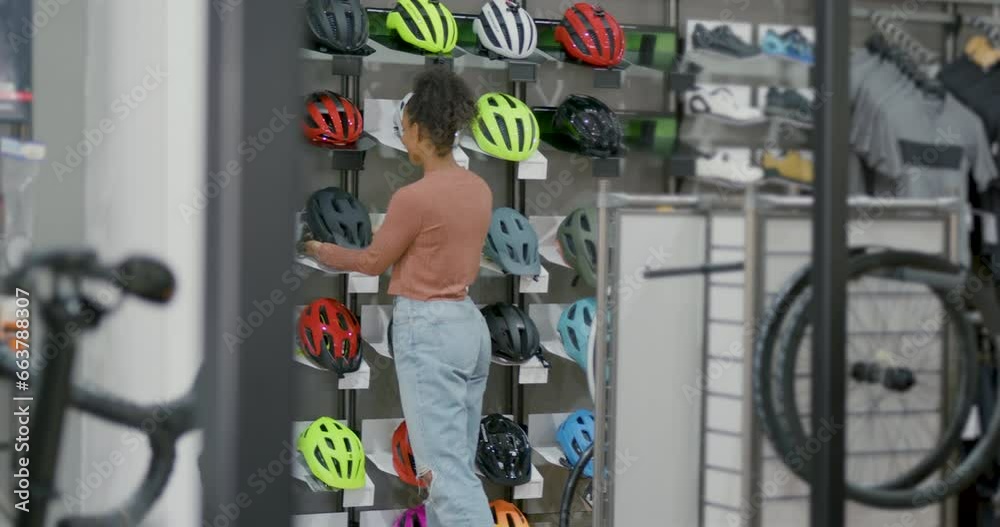 Female Bicycle Store Customer Looking for Cycle Helmet Female Bicycle Store Customer Looking for Cycle Helmet
