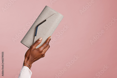 Fashion african woman hand holding glitter clutch bag photo