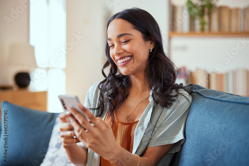 Cheerful multiethnic woman messaging on phone photo