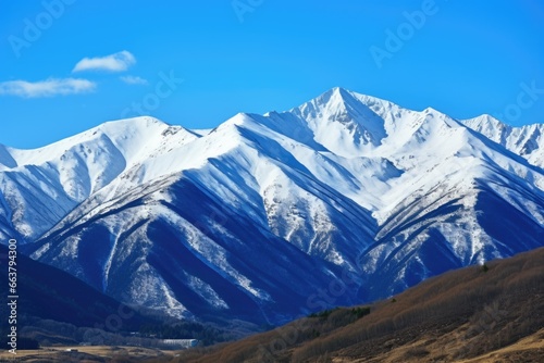 a snow-capped mountain backdrop under clear blue sky © Alfazet Chronicles