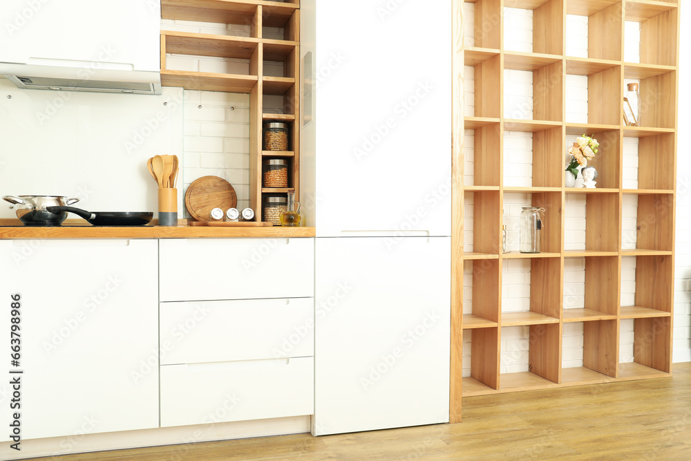 © Atlas - Modern kitchen in white colors and wooden shelves