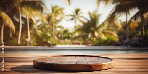 Empty round wooden podium on wooden table opposite tropical spa resort background with palm trees. © Svitlana
