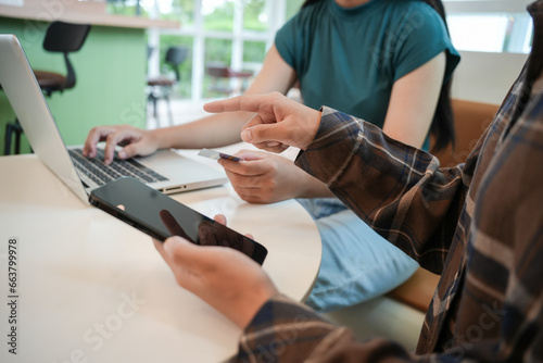 Woman shopping on laptop holding credit card for Internet onlin