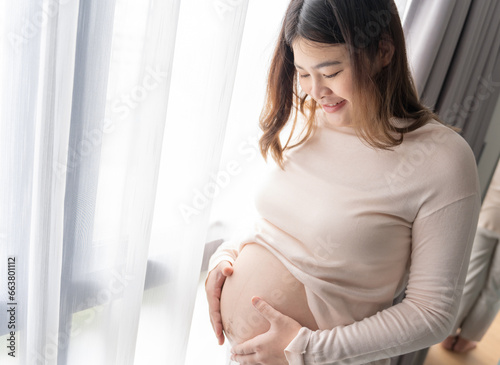 Pregnant asian woman holds hands on belly touching her baby caring about her health Beautiful happy pregnant woman tender mood photo of pregnancy Free Download Pregnant asian woman holds hands on belly touching her baby caring about her health Beautiful happy pregnant woman tender mood photo of pregnancy - GFXLoad