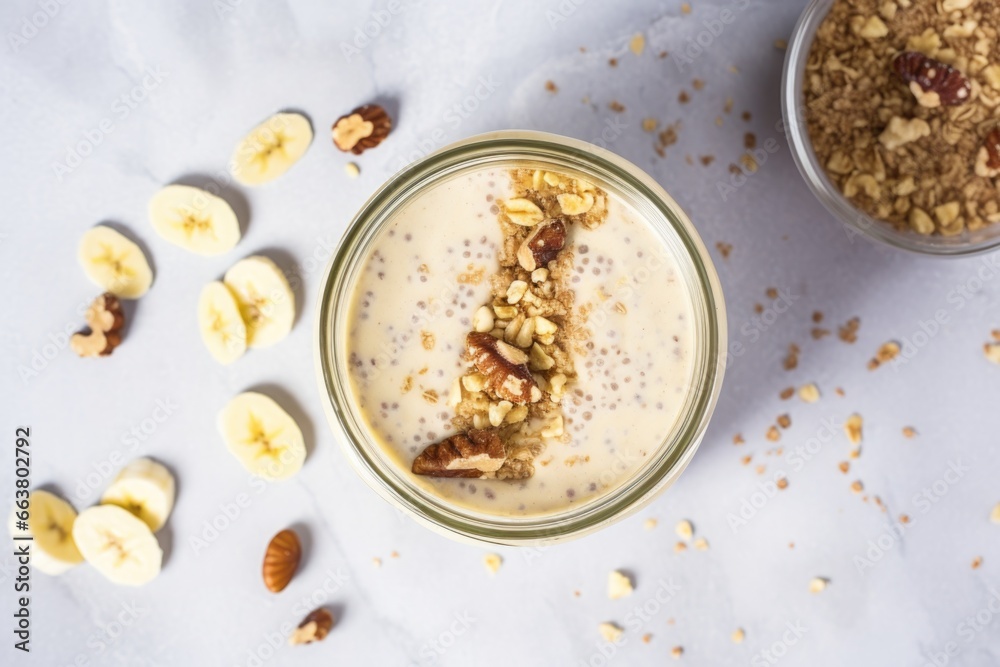 top view of a walnut banana smoothie in a mason jar top view of a walnut banana smoothie in a mason jar