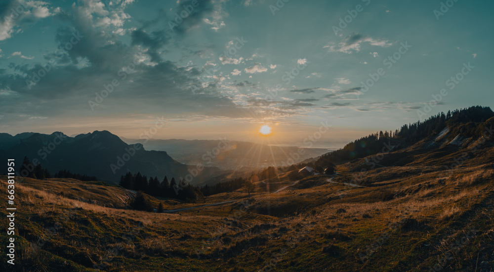 Warm sunset on a late summer evening in the Austrian mountains with view on Lake of Constance in the distance