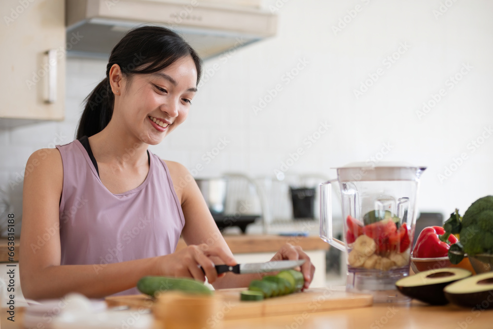 Young Asian healthy beautiful woman with casual clothes is smile and slicing fresh fruit to diet at home in kitchen in holiday Young Asian healthy beautiful woman with casual clothes is smile and slicing fresh fruit to diet at home in kitchen in holiday