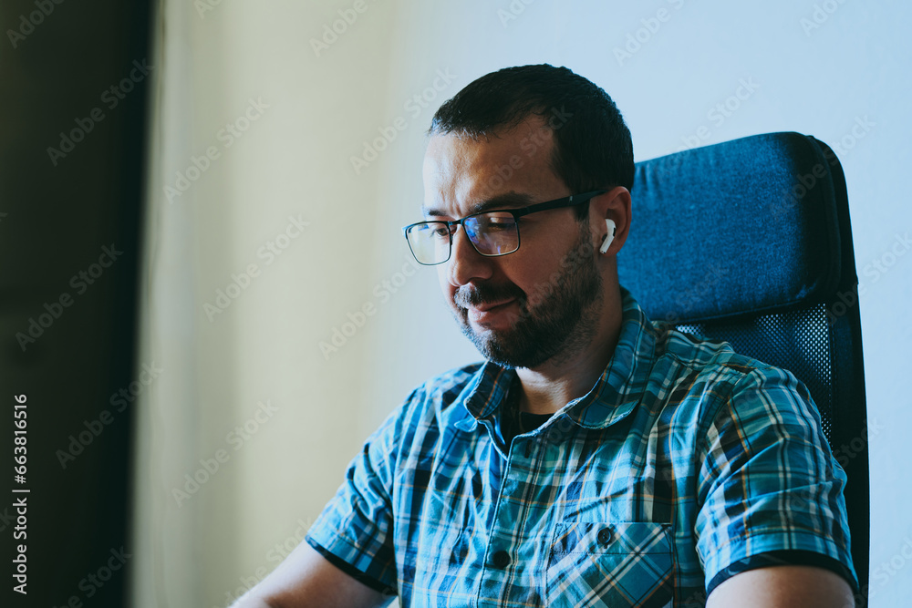 Fototapeta premium Portrait professional man programmer working concentrated on computer in diverse offices. Modern IT technologies, development artificial intelligence, programs, applications and video games concept.