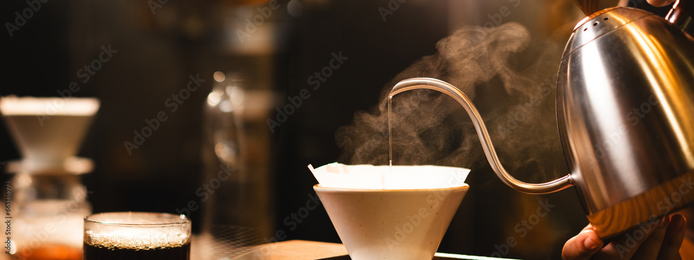 Barista brewing filter or drip coffee in loft coffee shop or cafe bar with copy space. Concept of slow bar banner or background, pouring coffee caffeine, traditional making process of coffee maker.