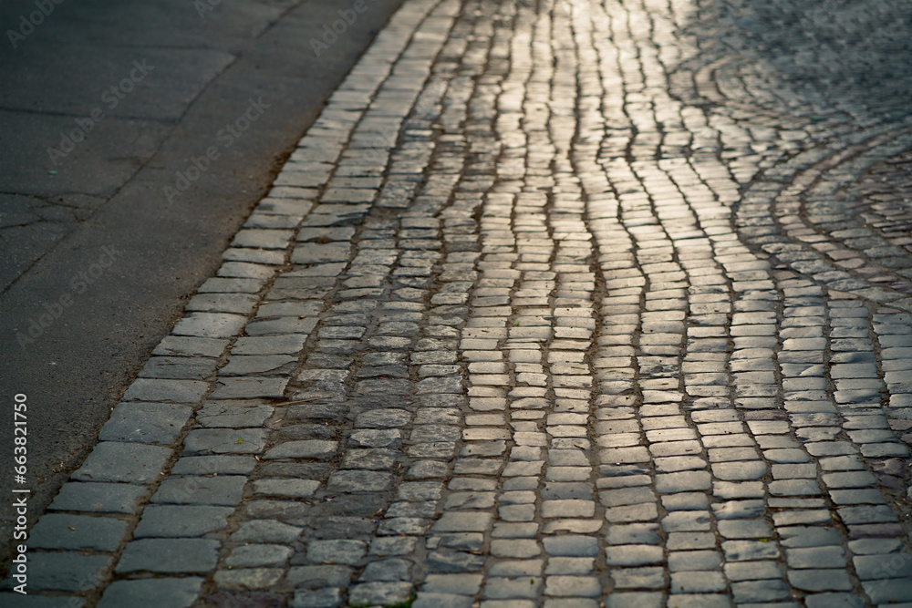 Stone pavement in perspective. Artistic texture and background. Element of the old street of the city of Lviv in Ukraine. Outdoor street design of the territory of natural stone. Difficult road with Stone pavement in perspective. Artistic texture and background. Element of the old street of the city of Lviv in Ukraine. Outdoor street design of the territory of natural stone. Difficult road with
