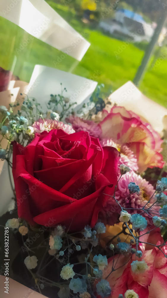 Fototapeta premium A bouquet of flowers from red, pink dahlia roses and others